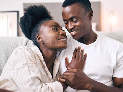 Buy stock photo Shot of a young couple relaxing together at home