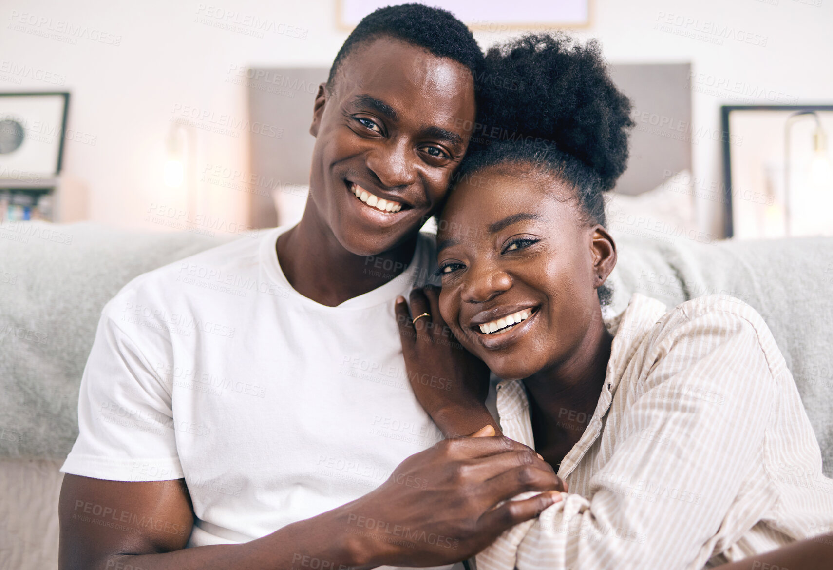 Buy stock photo Shot of a young couple relaxing together at home