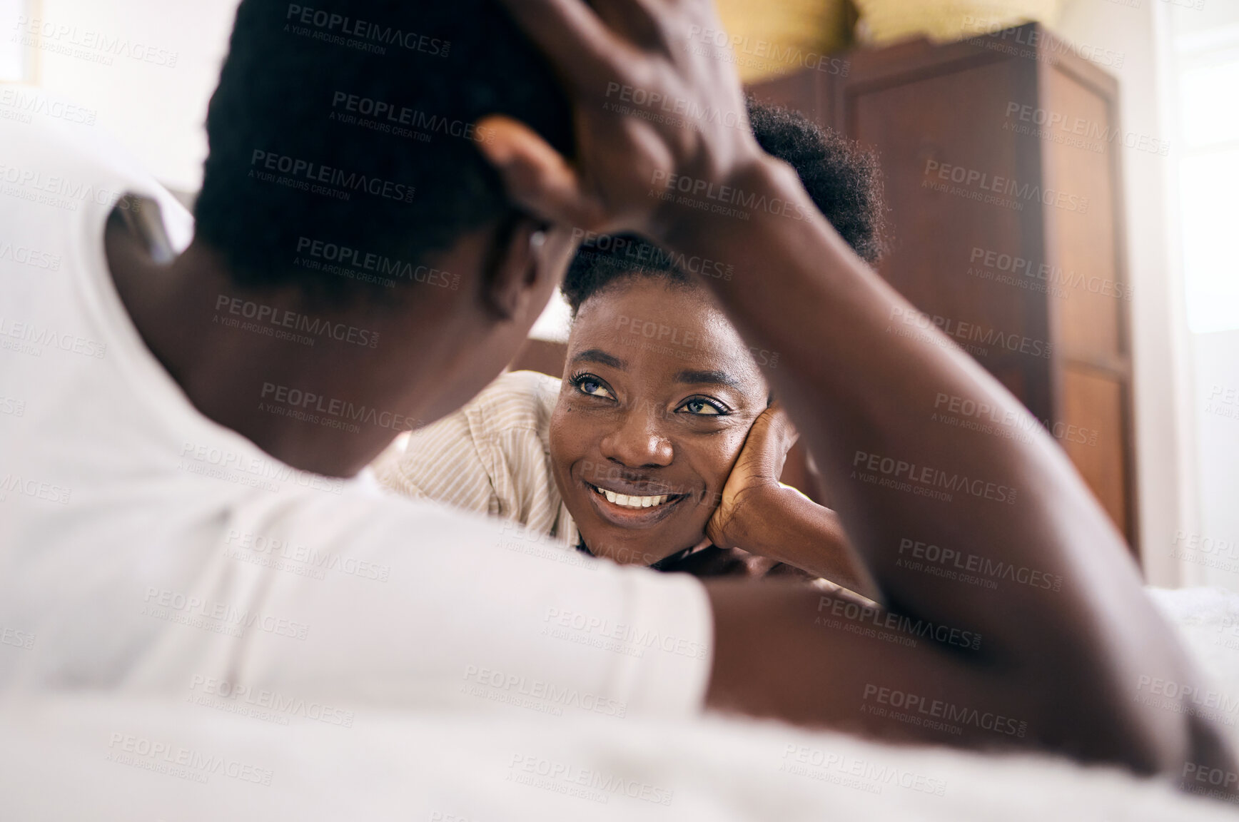 Buy stock photo Shot of a young couple relaxing together at home