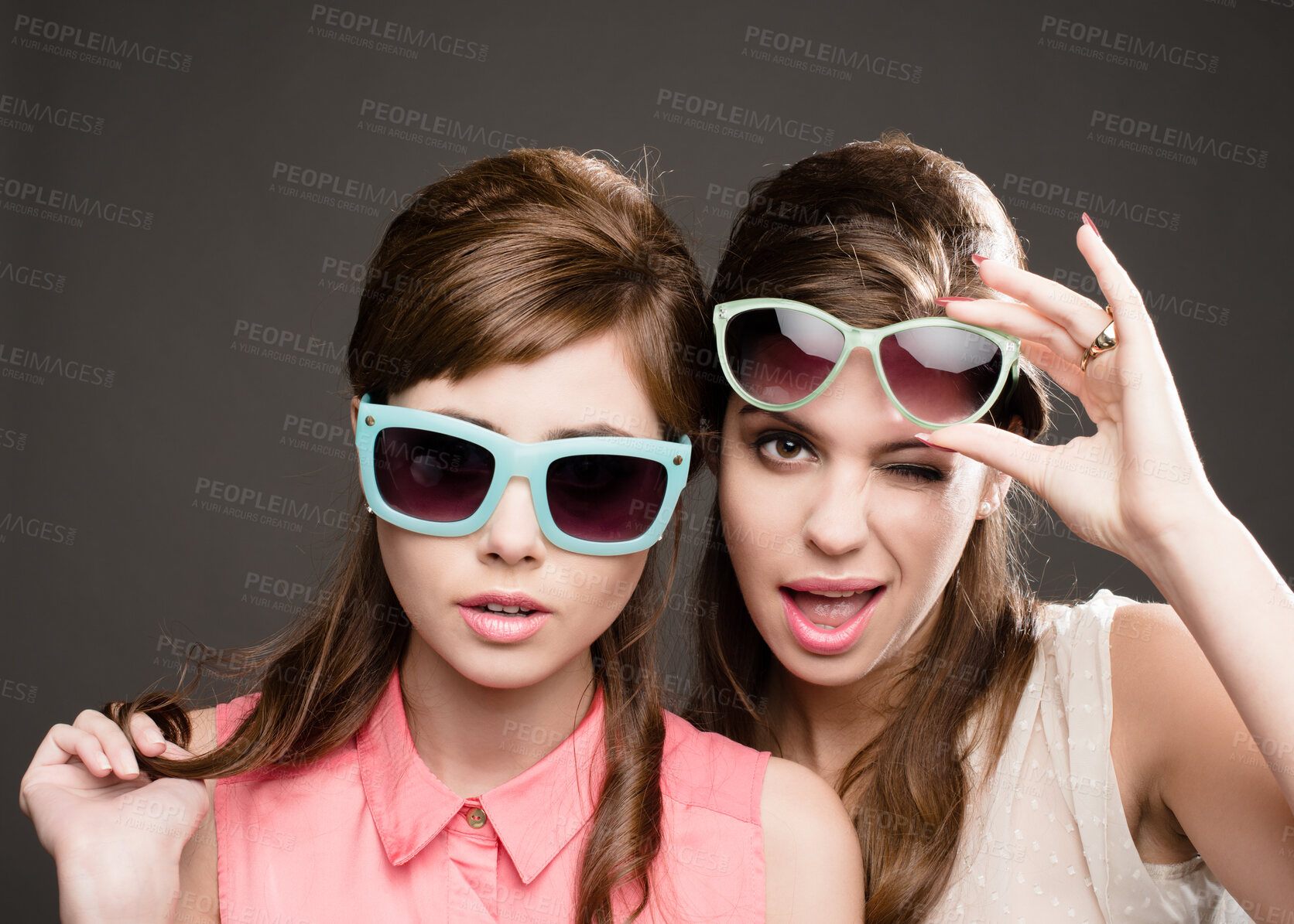 Buy stock photo Fashion, vintage and wink with portrait of women in studio for elegant, pastel and beauty. Sunglasses, confident and cosmetics with female model on dark background for glamour, beehive and style