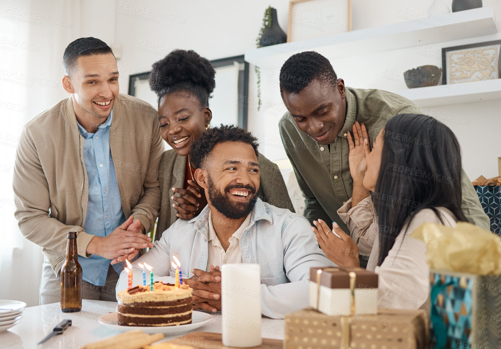 Buy stock photo Shot of a young man celebrating his birthday with friends at home