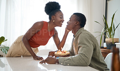 Buy stock photo Shot of a young woman celebrating her boyfriend's birthday with him at home