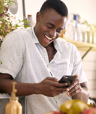 Buy stock photo Shot of a young man using a phone at home