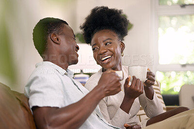 Buy stock photo Shot of a young couple drinking coffee together at home