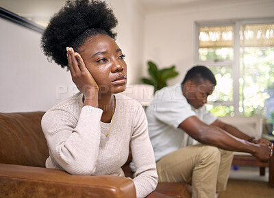 Buy stock photo Shot of a young couple in an argument at home