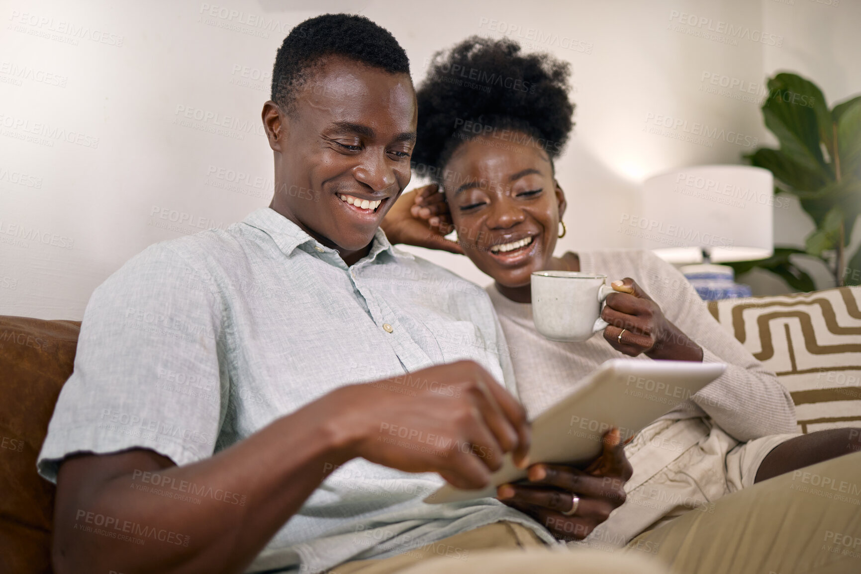 Buy stock photo Shot of a young couple using a digital tablet together at home