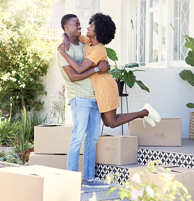 Buy stock photo Shot of a young couple moving into their new house
