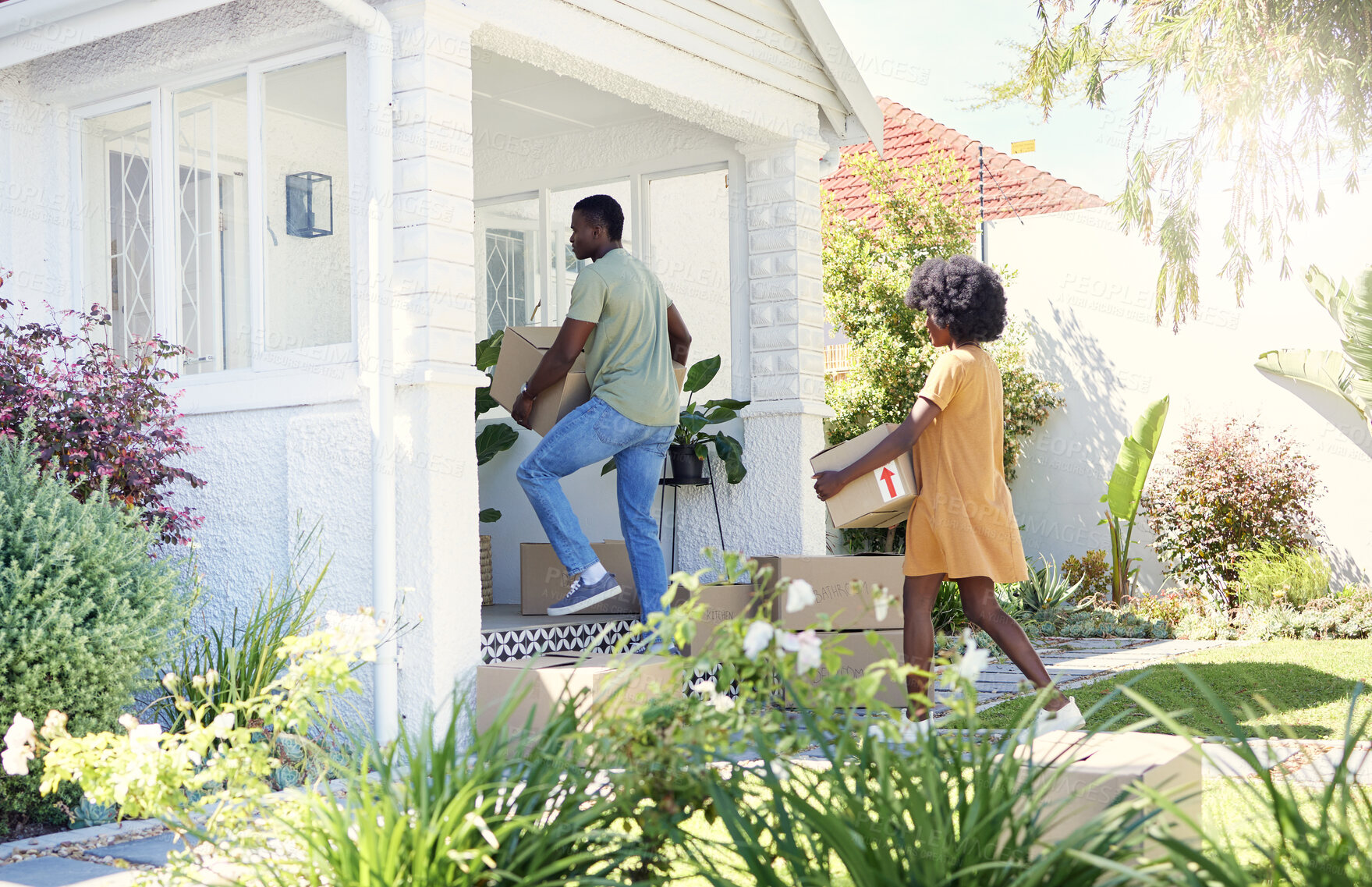 Buy stock photo Shot of a young couple moving into their new house