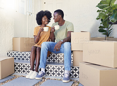Buy stock photo Shot of a young couple drinking coffee while moving into their new house