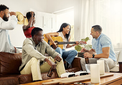 Buy stock photo Shot of a woman playing the guitar while sitting in a living room with her friends