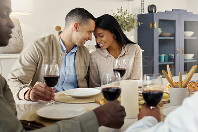 Buy stock photo Shot of an affectionate couple sitting together at a dining table