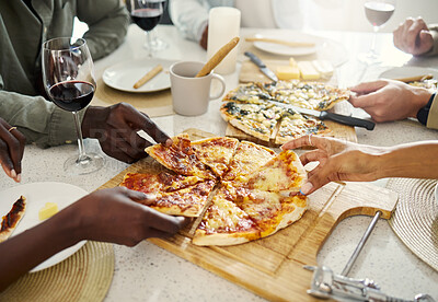Buy stock photo Cropped shot of an unrecognizable group of people eating pizza together
