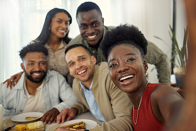 Buy stock photo Shot of a woman taking a selfie with a group of friends at home