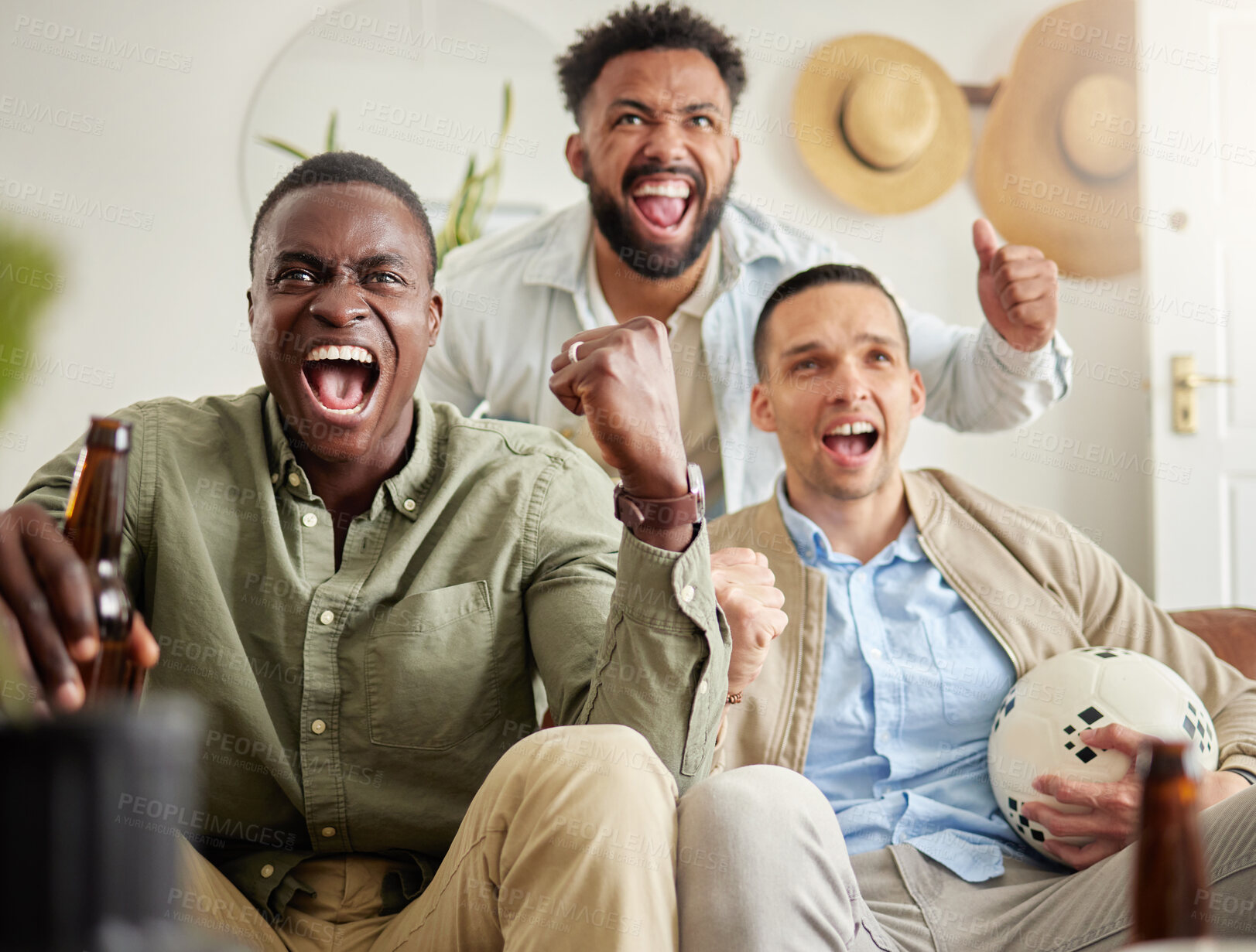 Buy stock photo Shot of three male friends looking cheerful while drinking beers and sitting together