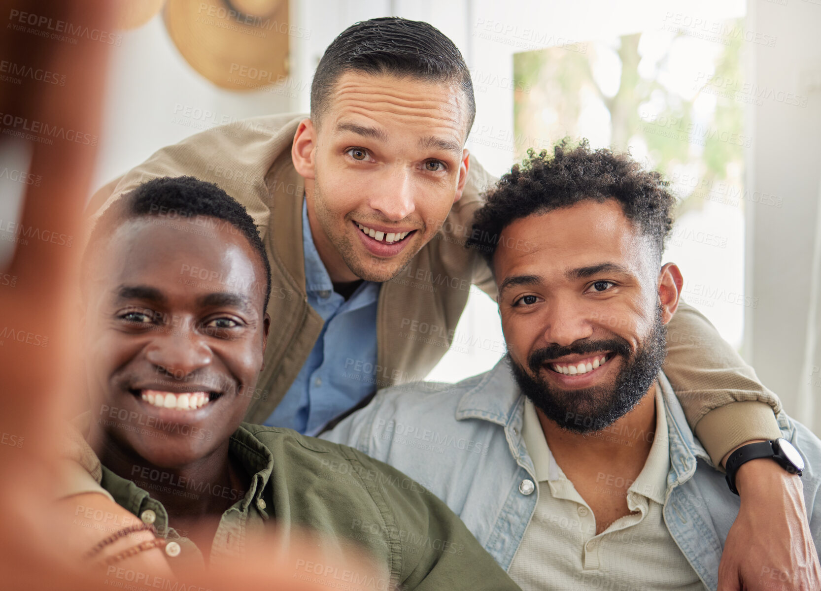 Buy stock photo Shot of a man taking a selfie with his two friends at home