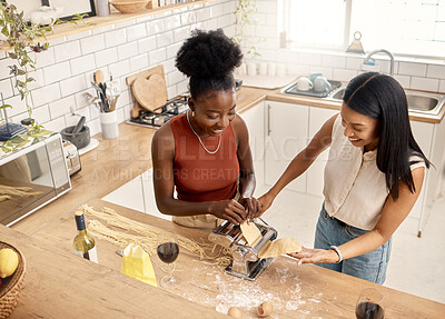 Buy stock photo Shot of two young friends cooking together at home