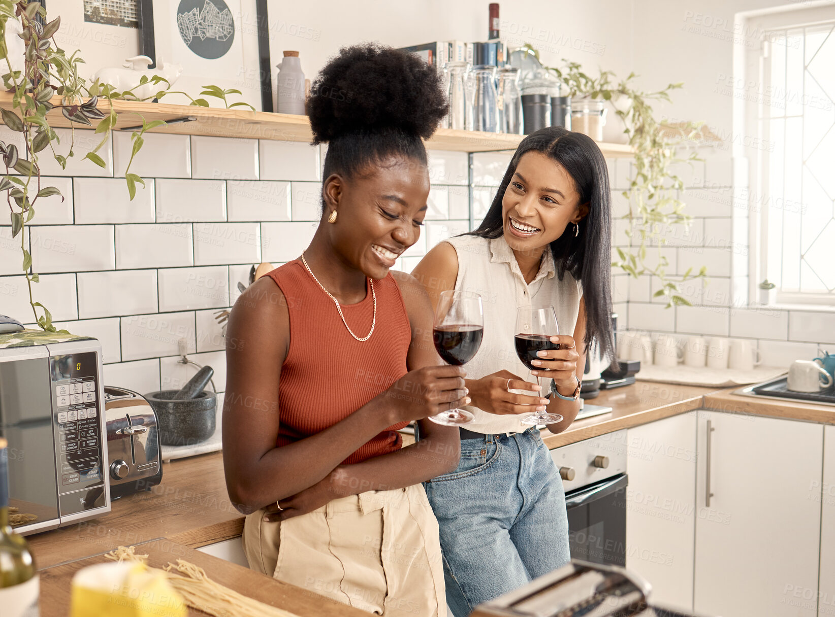Buy stock photo Friends, women and laughing with wine in kitchen, storytelling and share funny experience for bonding. Alcohol, gossip and happy people with conversation for connection, home and hang out on weekend