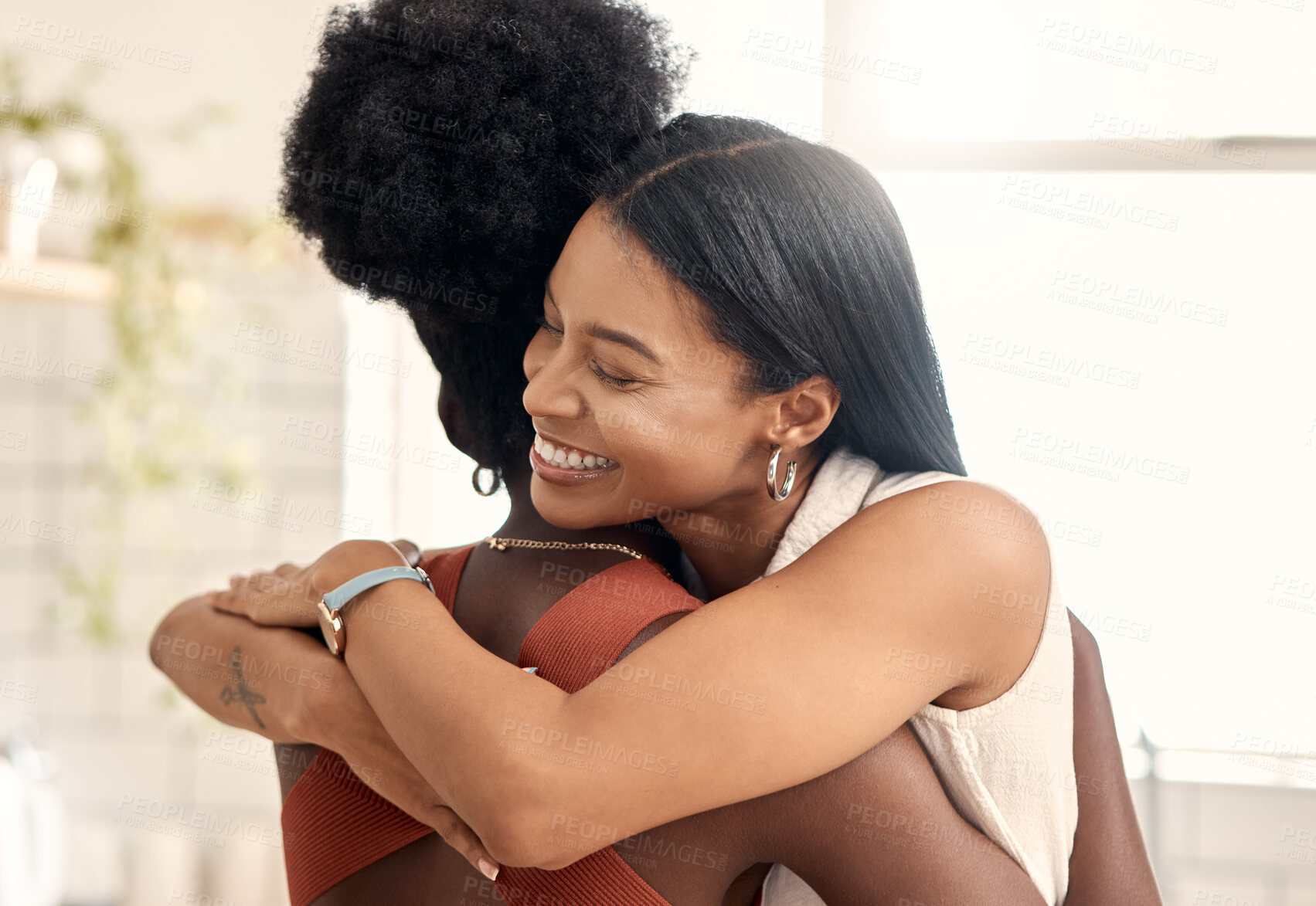 Buy stock photo Shot of two young friends spending time together at home