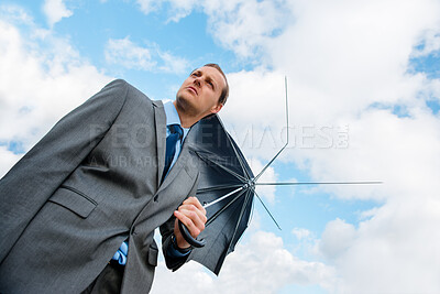 Buy stock photo Businessman, thinking and outdoor with broken umbrella, insurance agent and blue sky for security fail. Male person, stress and anxiety for bankruptcy crisis, professional mistake and low angle