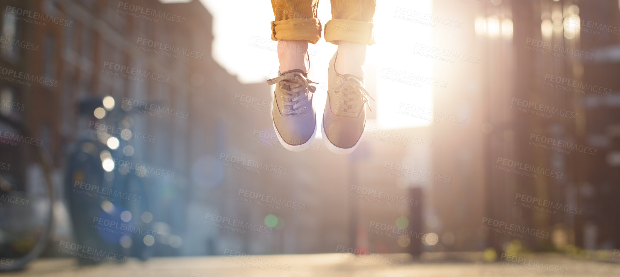 Buy stock photo Legs of child, shoes and floating in air outside for celebration, success and achievement for adoption. Levitate, feet and kid jumping in urban city for victory, hopping or good news as prize winner