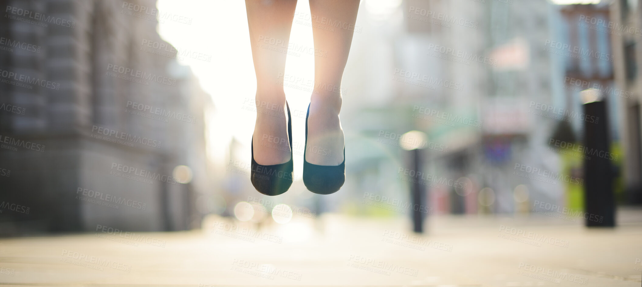 Buy stock photo Feet, woman and jumping in air outdoor for celebration, success and achievement with lens flare. Business person, foot and legs in closeup in city for victory, hopping and good news as prize winner