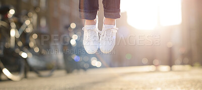 Buy stock photo Feet, shoes and jump in city outdoor for celebration, success and achievement with lens flare. Person, carefree and legs in closeup outside for victory, hopping and good news as competition winner