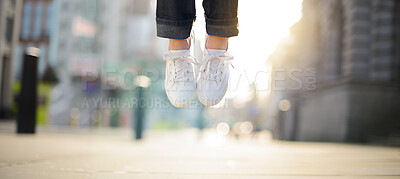 Buy stock photo Child, shoes and jumping in air outdoor for celebration, success and achievement with lens flare. Young person, foot and legs in closeup outside for victory, hopping and good news as prize winner