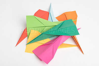 Buy stock photo Paper, creative and art with plane in studio for colorful, invention and design of handmade craft. Geometric, shape and pile with jet by white background for origami stack, aerodynamic and flight