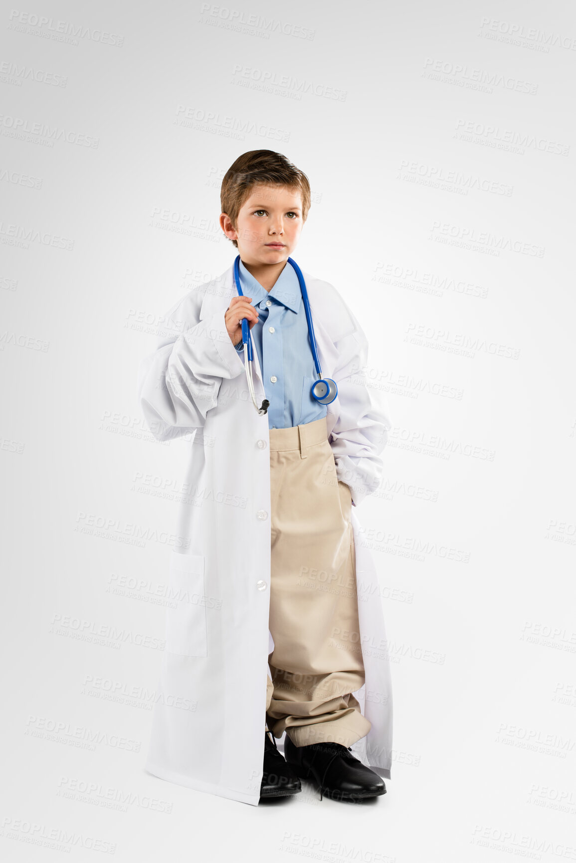 Buy stock photo Little boy, doctor and ambition with stethoscope or uniform in studio for checkup or healthcare on a white background. Child, kid or junior cardiologist with health tool or equipment for wellness