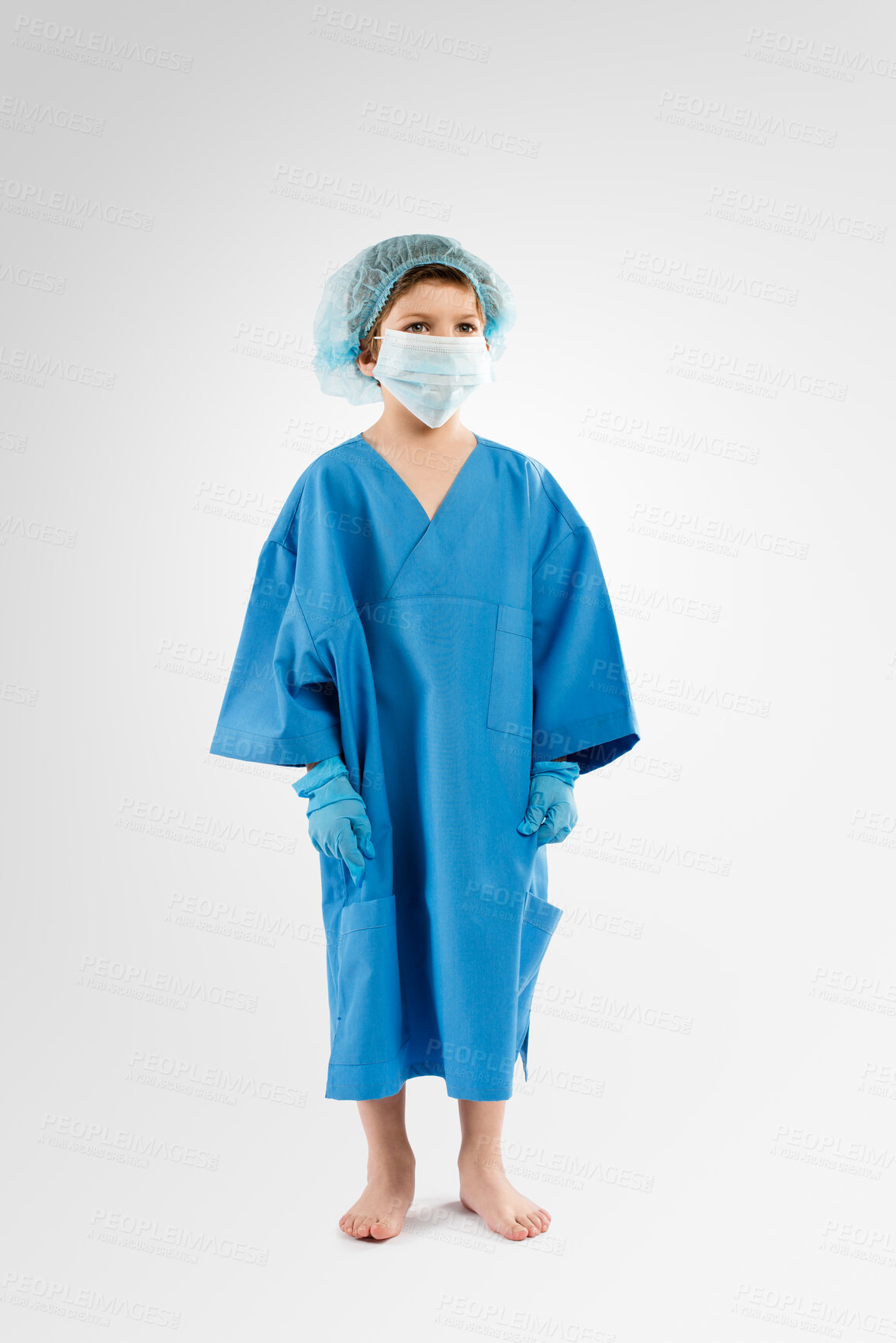 Buy stock photo Little boy, scrub and ambition with medical mask or uniform in studio for surgery or care on a white background. Child, kid or junior surgeon with health equipment for safety, protection and wellness