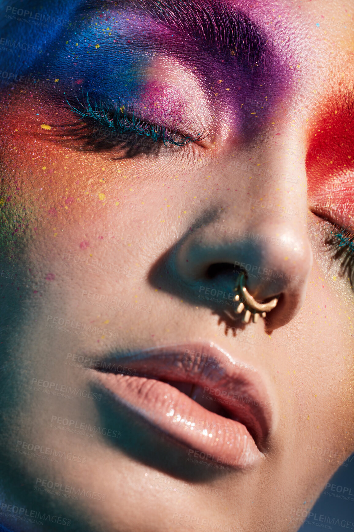 Buy stock photo Studio shot of a young woman posing with multi-coloured paint on her face