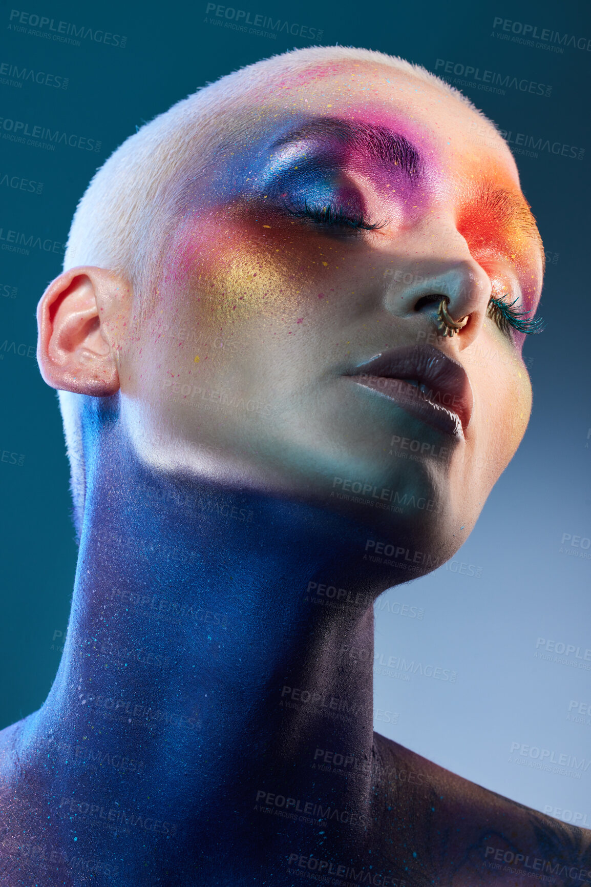 Buy stock photo Studio shot of a young woman posing with multi-coloured paint on her face