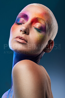 Buy stock photo Studio shot of a young woman posing with multi-coloured paint on her face