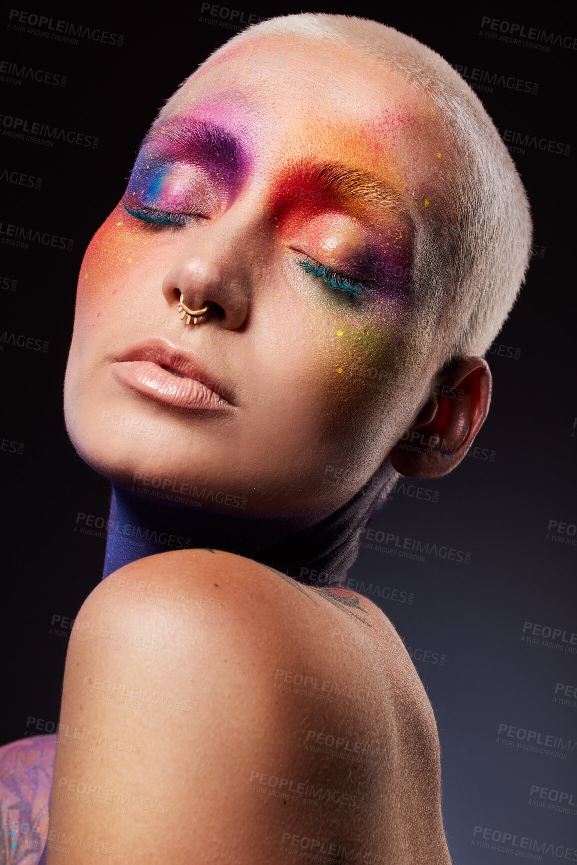 Buy stock photo Studio shot of a young woman posing with multi-coloured paint on her face