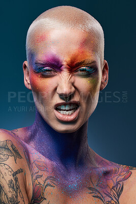 Buy stock photo Studio shot of a young woman posing with multi-coloured paint on her face