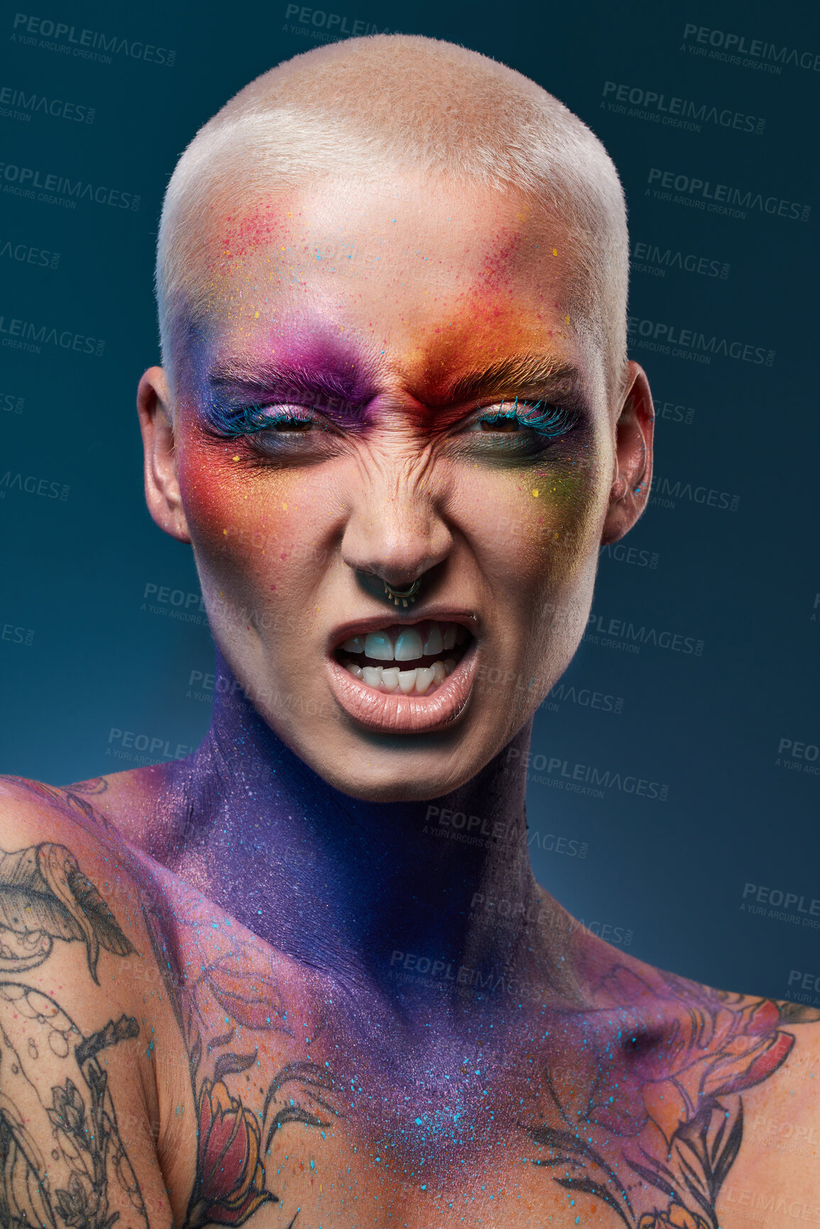 Buy stock photo Studio shot of a young woman posing with multi-coloured paint on her face