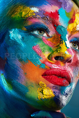 Buy stock photo Studio shot of a young woman posing with multi-coloured paint on her face