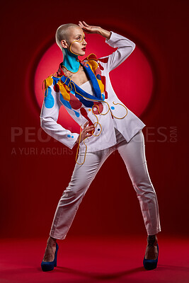 Buy stock photo Studio shot of a stylish young woman posing against a red background