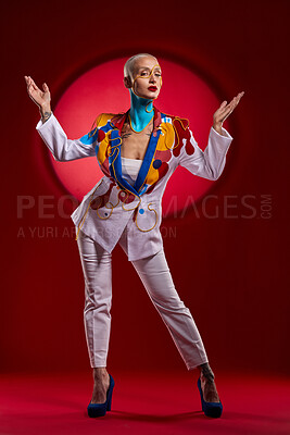 Buy stock photo Studio shot of a stylish young woman posing against a red background