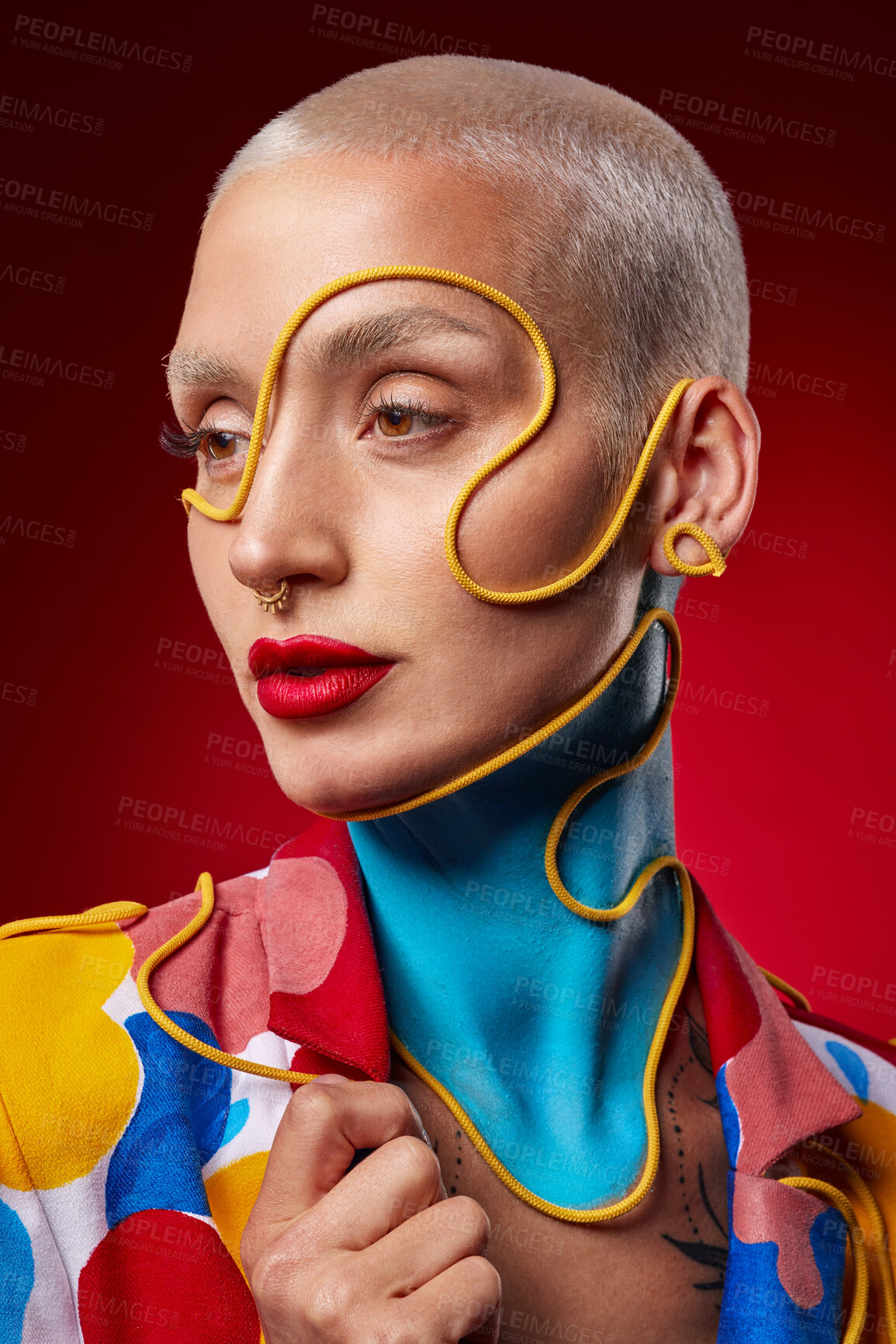 Buy stock photo Studio shot of a stylish young woman posing against a red background