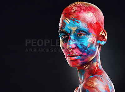 Buy stock photo Shot of an attractive young woman posing alone in the studio with paint on her face