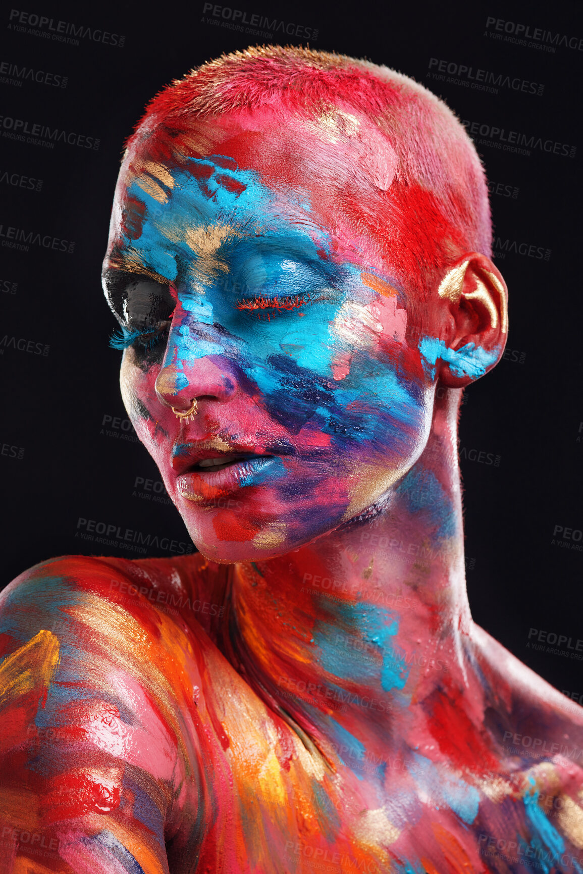 Buy stock photo Shot of an attractive young woman posing alone in the studio with paint on her face and body