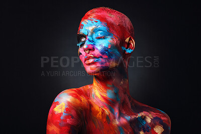 Buy stock photo Shot of an attractive young woman posing alone in the studio with paint on her face and body