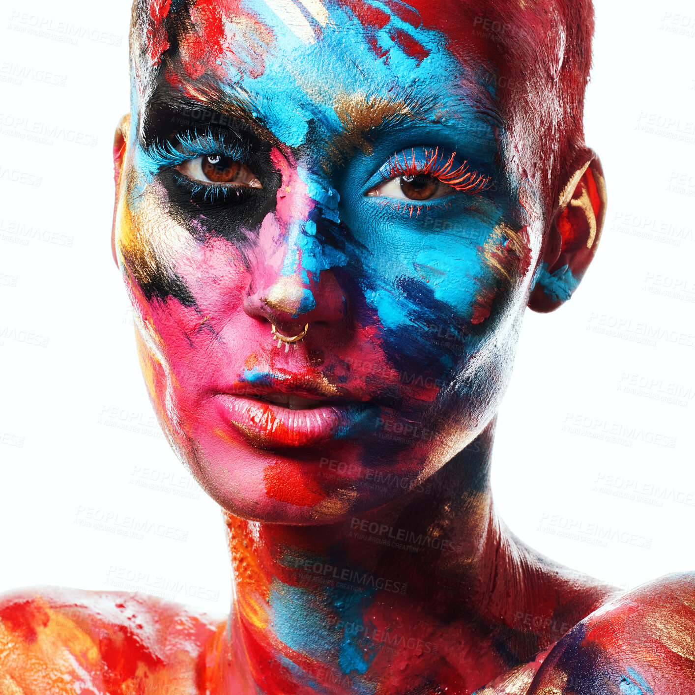 Buy stock photo Shot of an attractive young woman posing alone in the studio with paint on her face