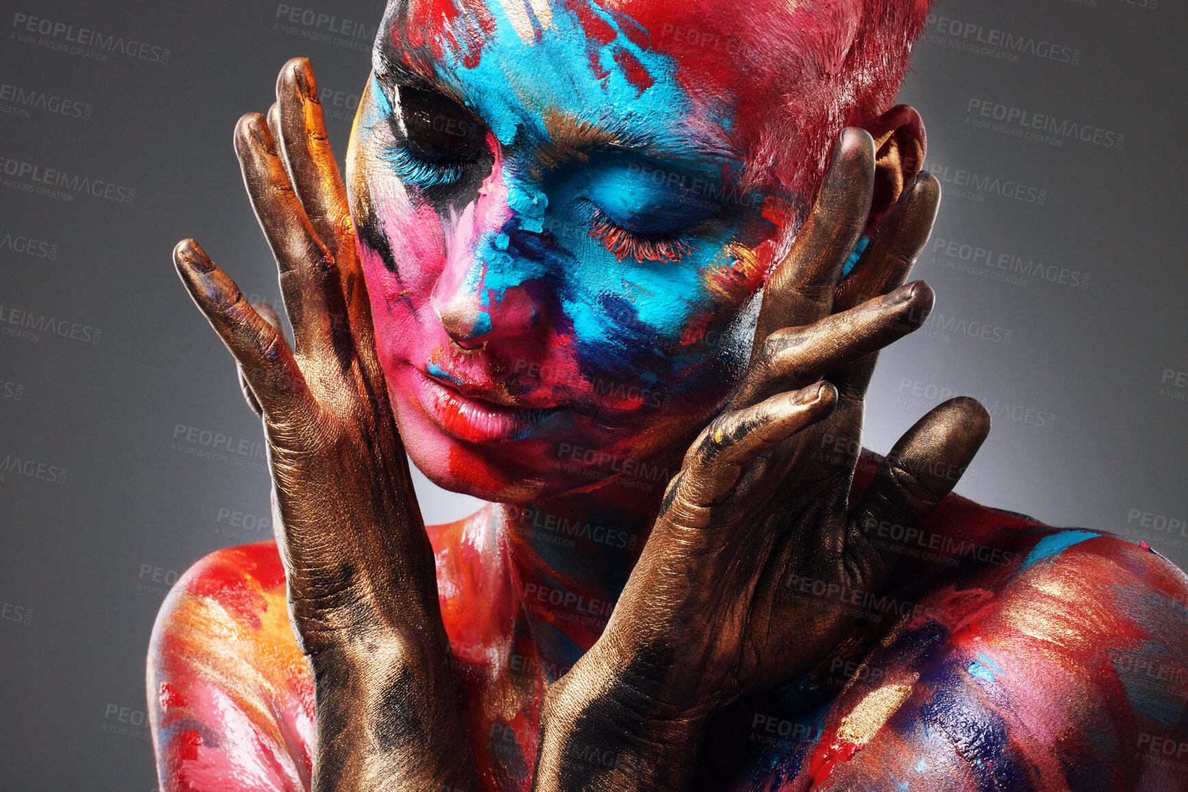 Buy stock photo Shot of an attractive young woman posing alone in the studio with paint on her face