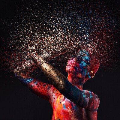 Buy stock photo Shot of a disintegration effect on a young woman posing in the studio with paint on her face and body