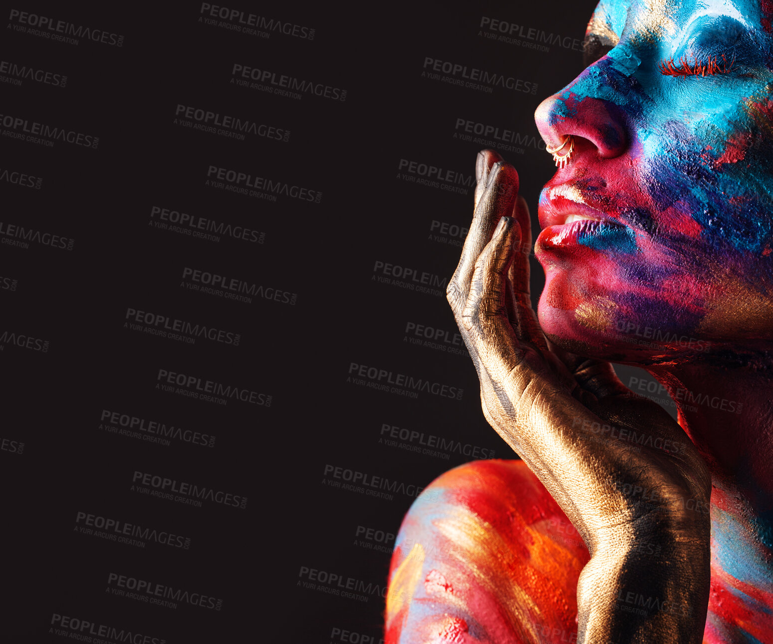 Buy stock photo Cropped shot of an attractive young woman posing alone in the studio with paint on her face