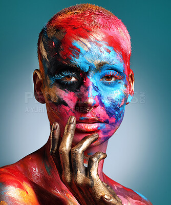 Buy stock photo Shot of an attractive young woman posing alone in the studio with paint on her face