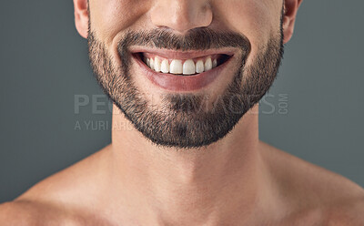 Buy stock photo Cropped shot of a man smiling against a grey background