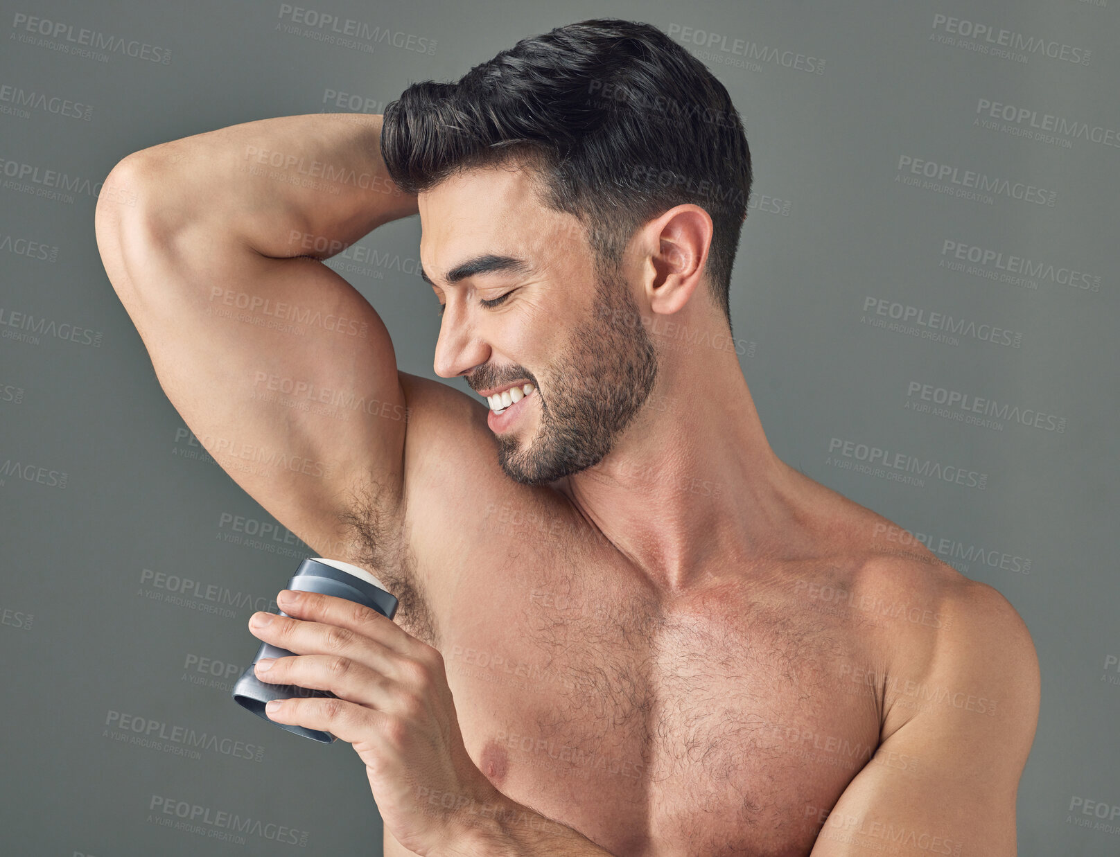 Buy stock photo Shot of a man applying deodorant to his underarms